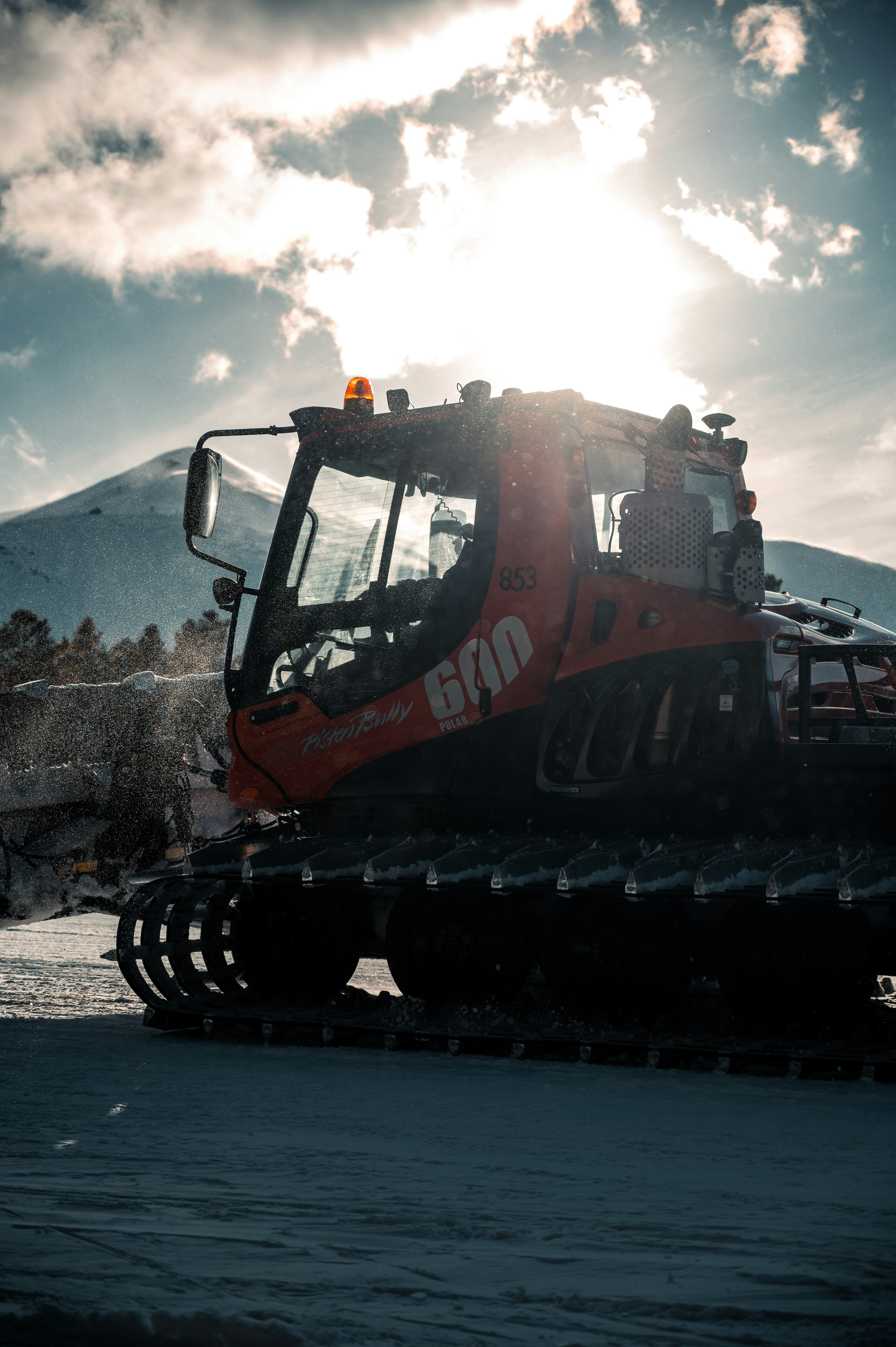 orange and black heavy equipment on snow covered ground during daytime